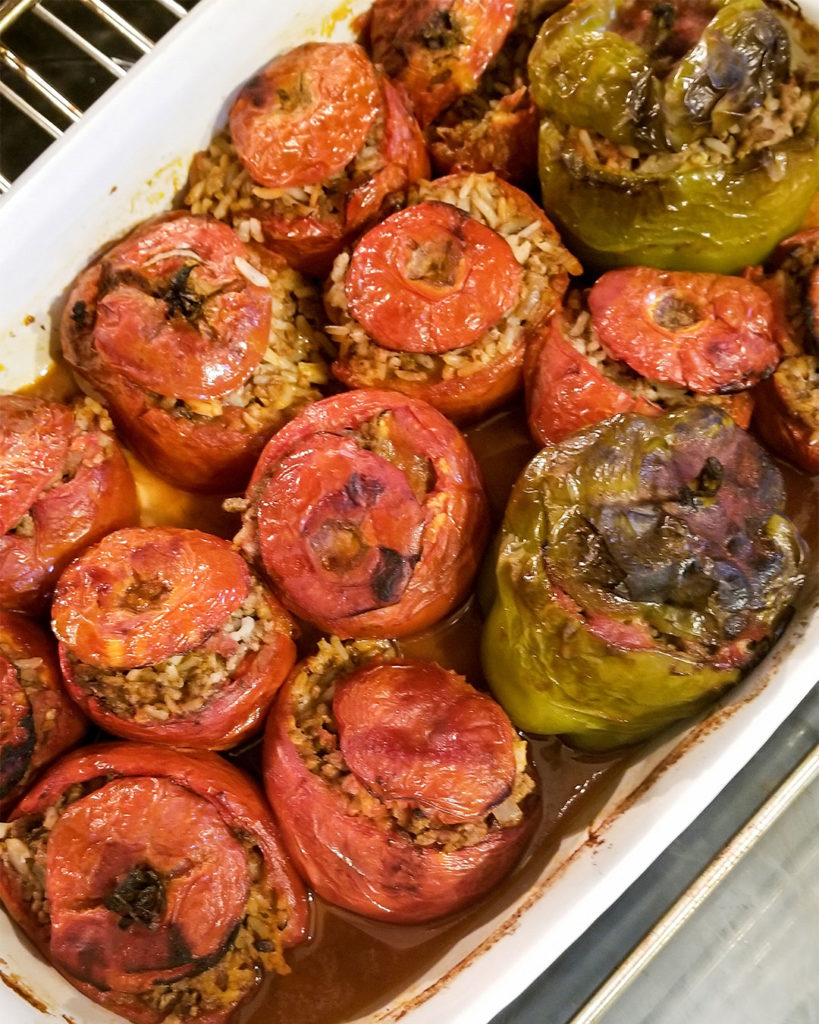 Yemista stuffed tomatoes and peppers cooking in the oven