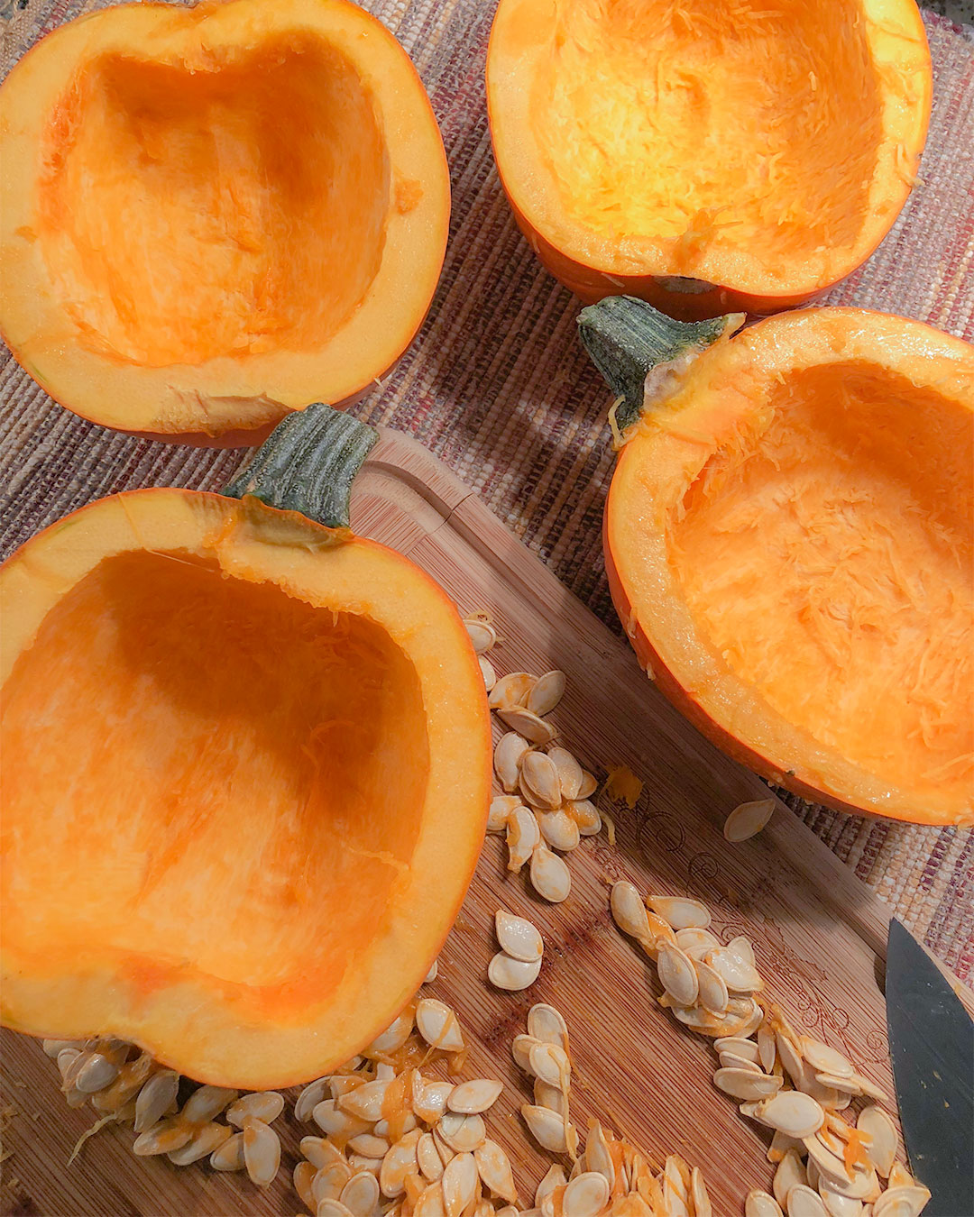 pumpkins cut in half lengthwise with the seeds scooped out