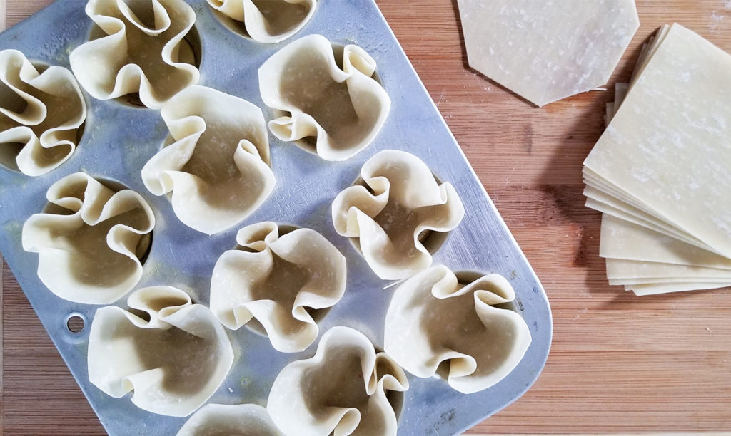 wonton wrappers in a muffin tin