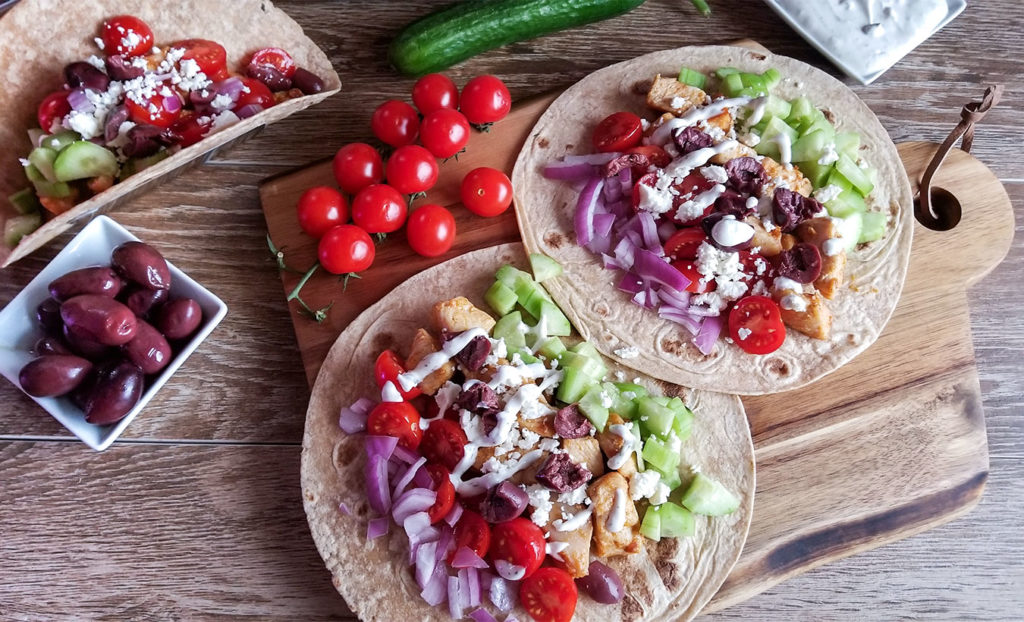 Grecian tacos topped with feta cheese and tzatziki sauce