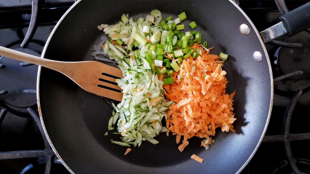 vegetables sautéing in a pan