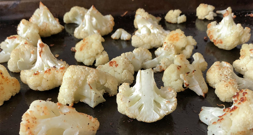 baked cauliflower florets on a baking sheet  