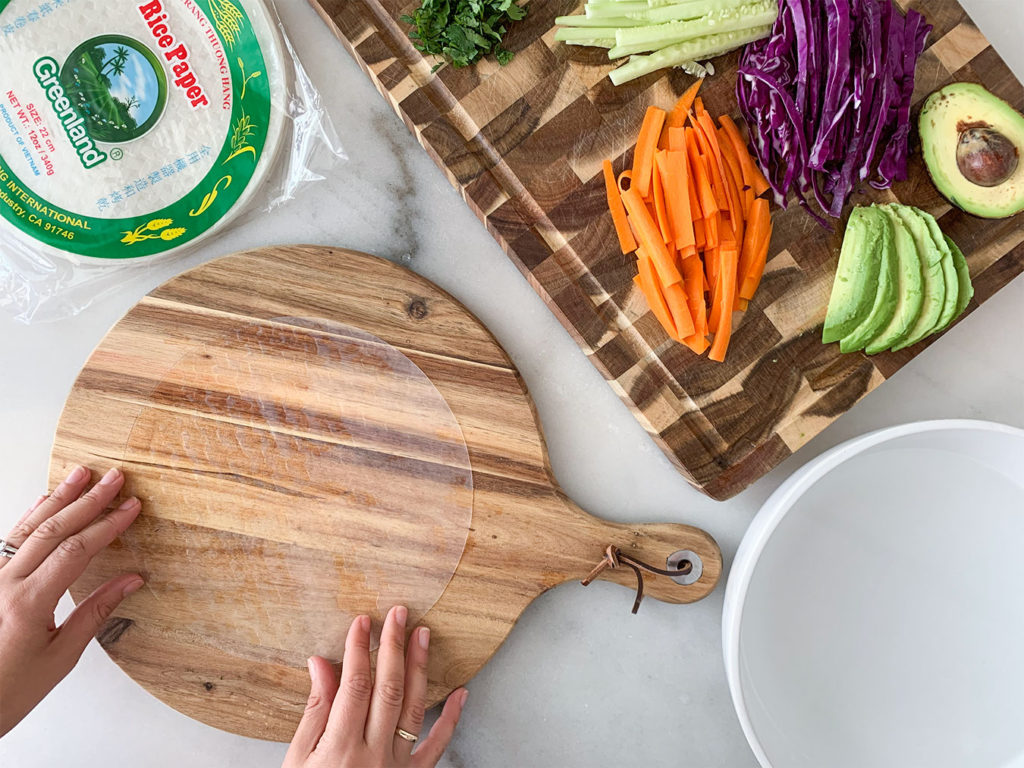 rice paper wrappers with Vegetable Summer Rolls ingredients on a cutting board