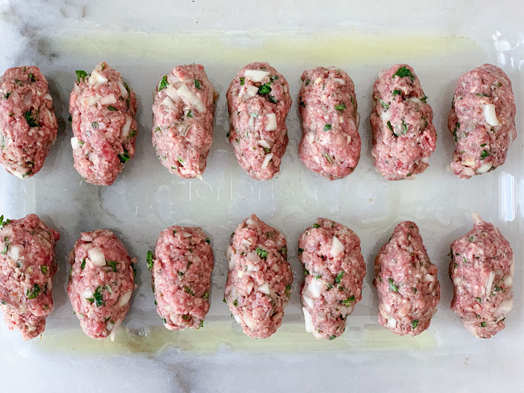 formed meatballs in a baking dish coated with olive oil