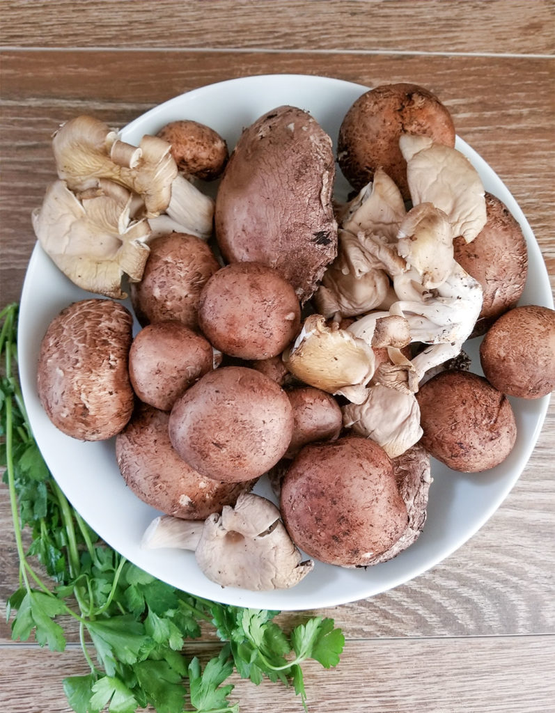 mushrooms in a bowl with fresh parsley