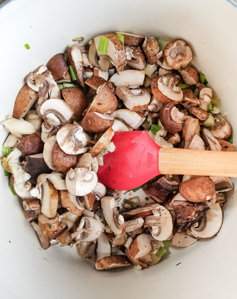 mushrooms sautéing in a pot