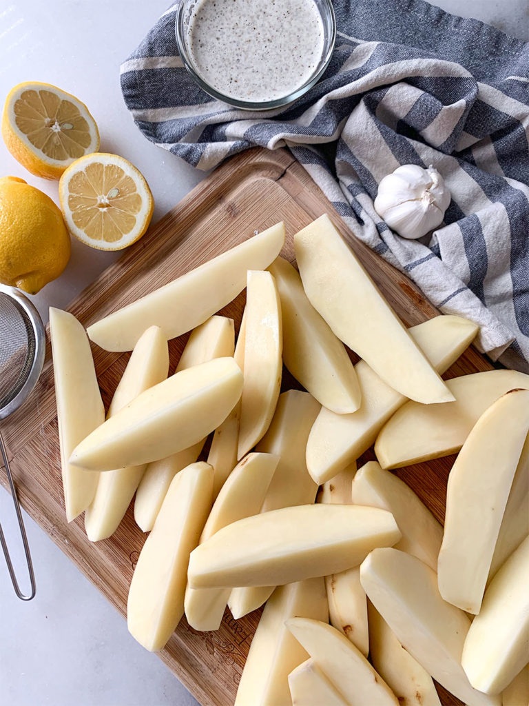 wedged potatoes, lemons and sauce