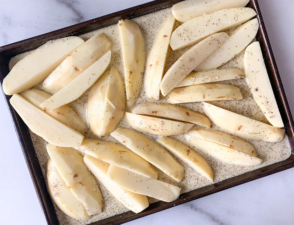 potatoes on a baking sheet covered in saue