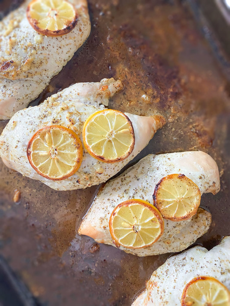 Cooked lemon chicken breasts on a sheet pan